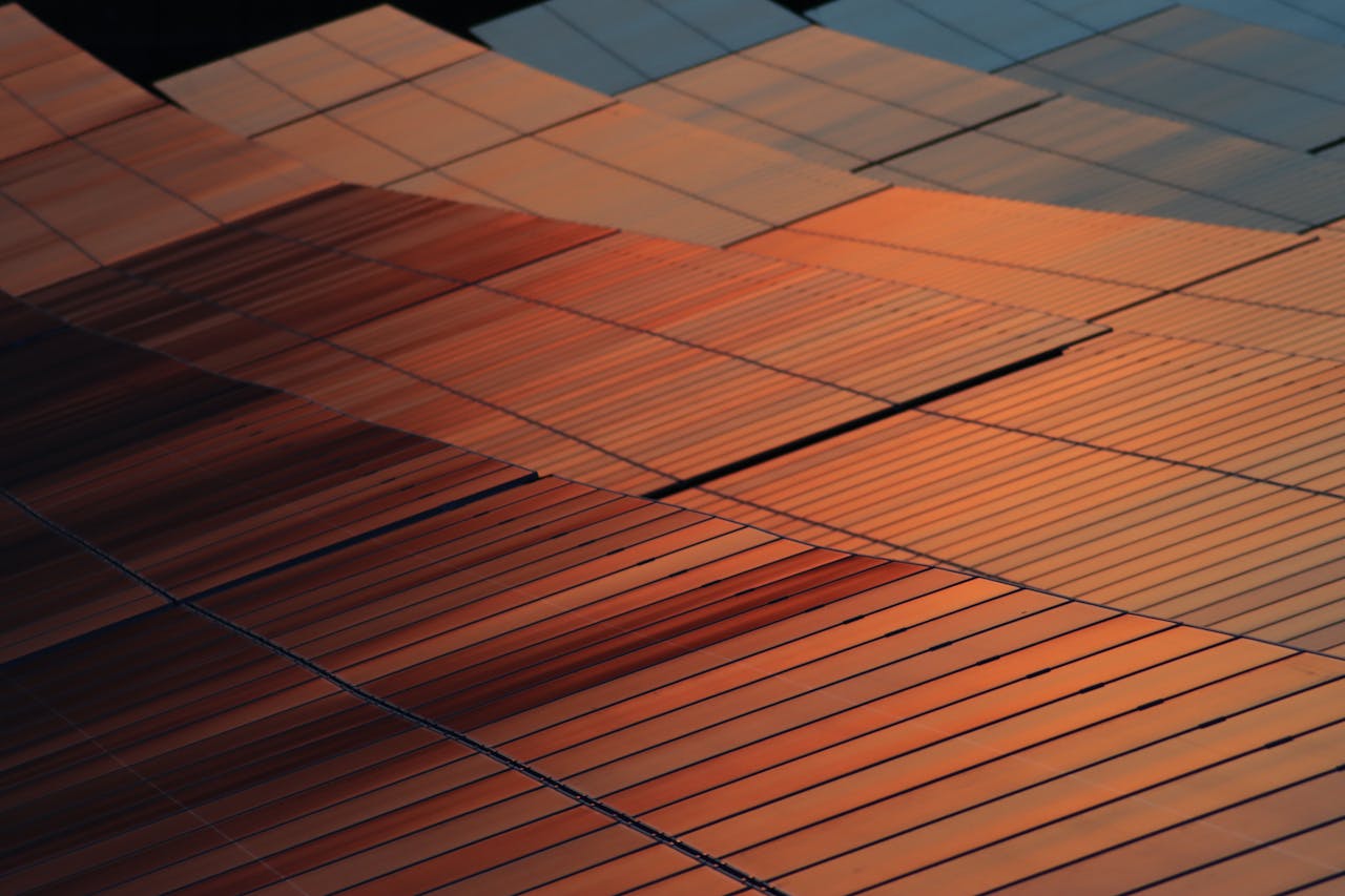 Close-up view of solar panels reflecting sunset light, illustrating renewable energy technology.