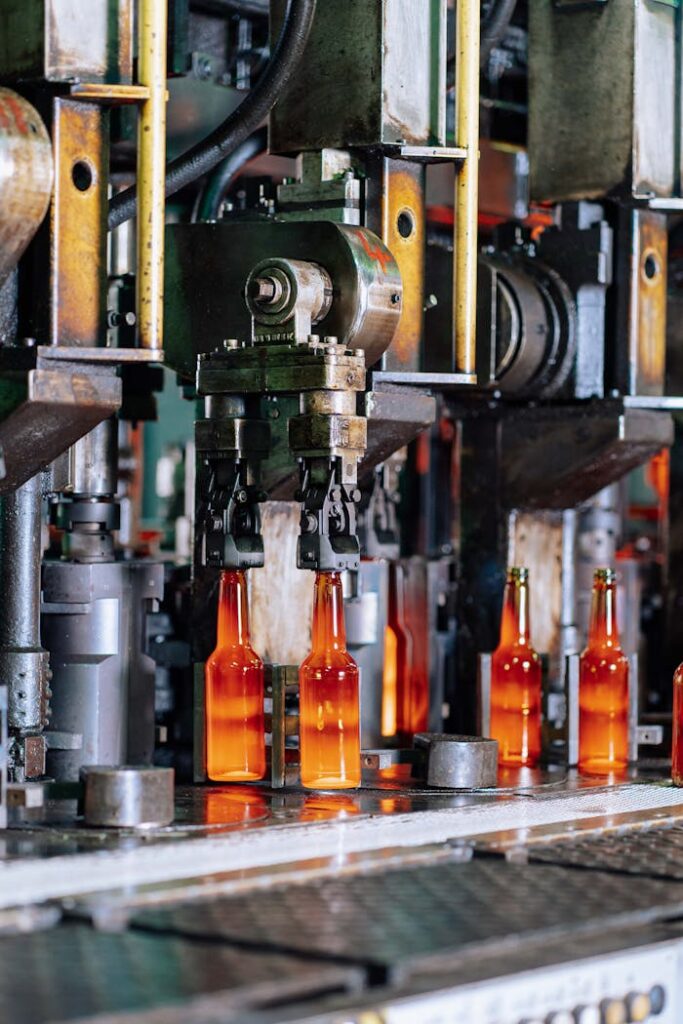 High-tech glass factory machines molding glass bottles in Dar es Salaam.